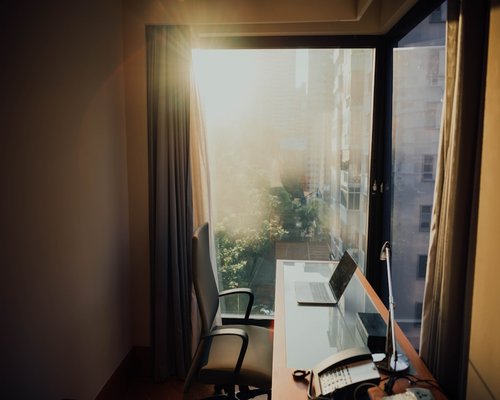 Sunlight hitting a modern desk next to a large window